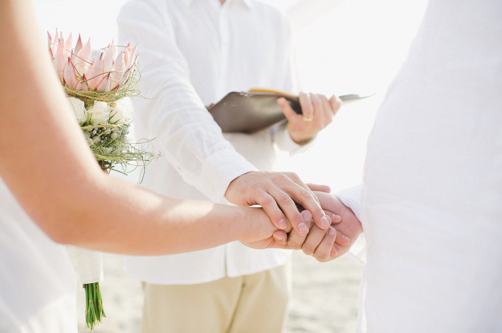 Photo Brautpaar reicht sich die rechte Hand.